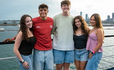 Group of three smiling parents at a community event