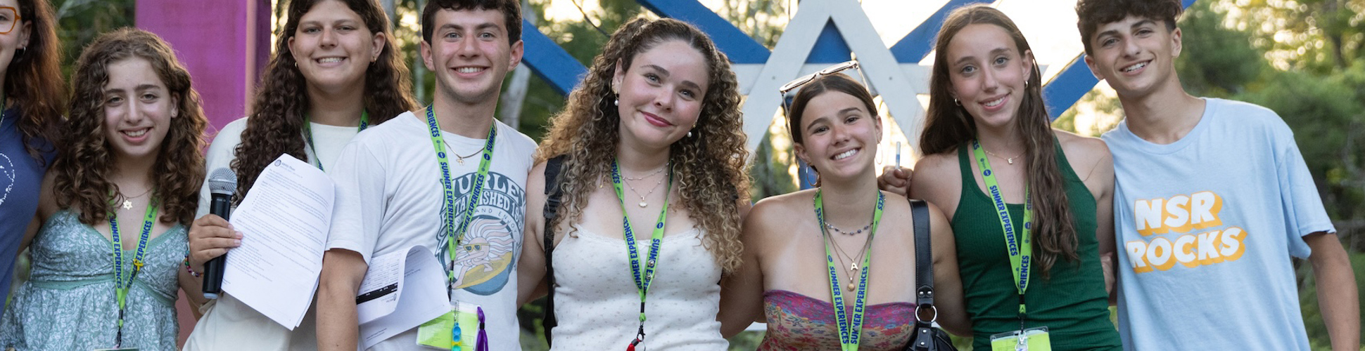Group of diverse young people smiling at a community event