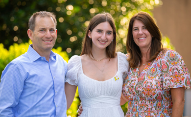 Group of three smiling parents at a community event