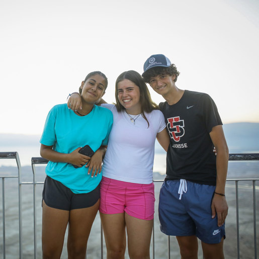 Three friends sitting on a hammock