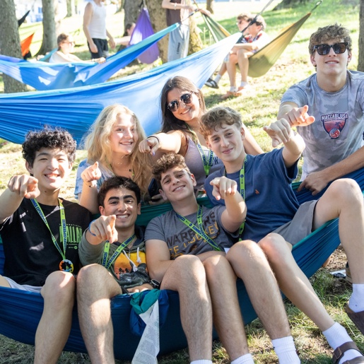 Three friends sitting on a hammock