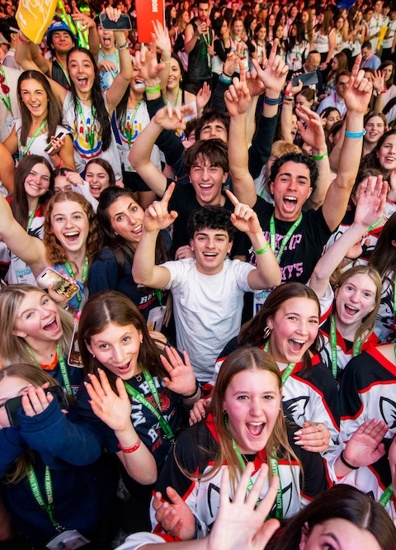 BBYO Centennial celebration with confetti, lights, and a crowd of attendees