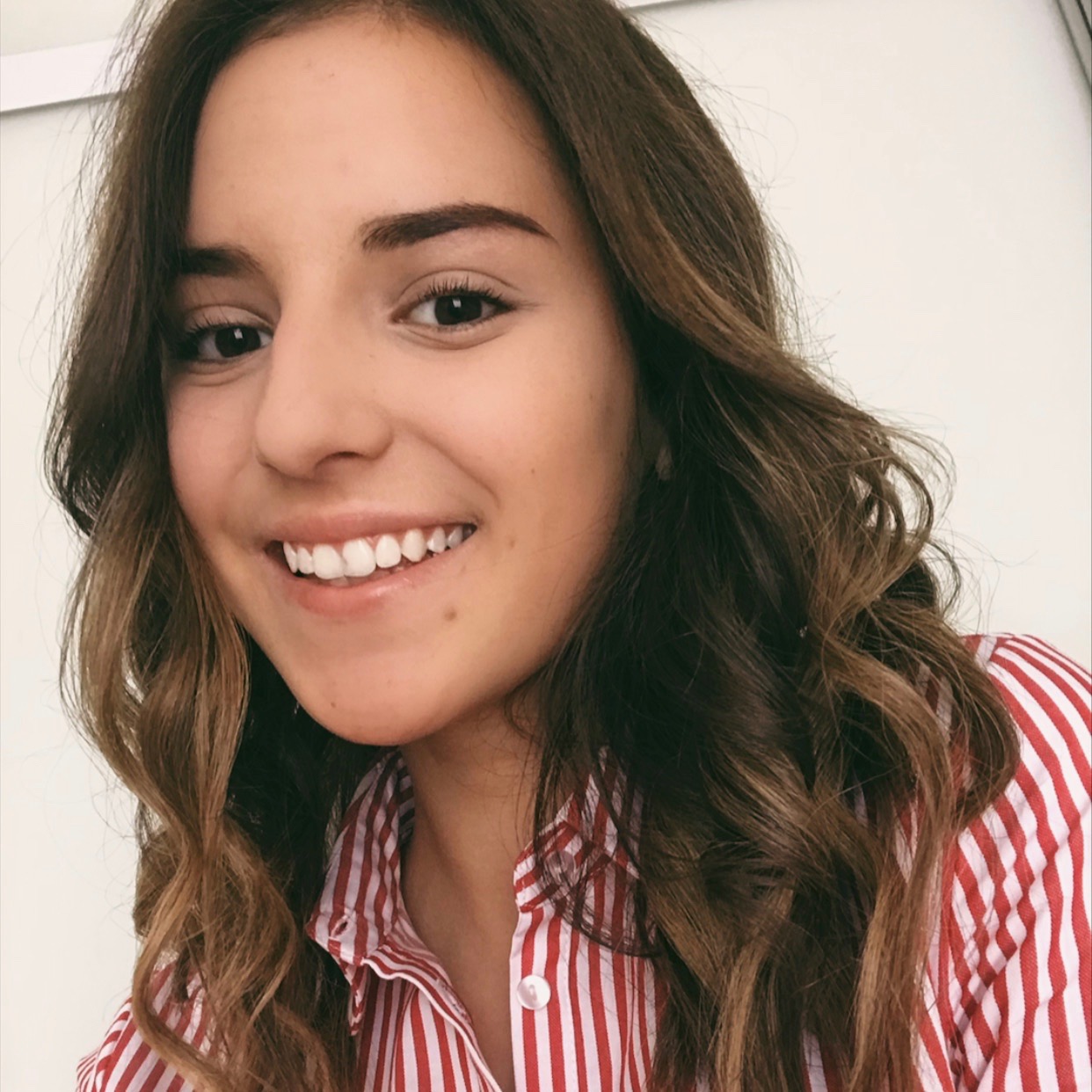 A diverse group of young adults jumping with excitement in a lush green garden during a community event.