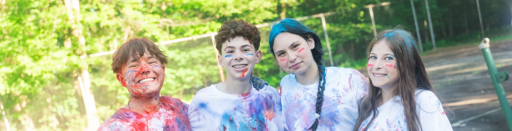 Group of diverse young people smiling at a community event
